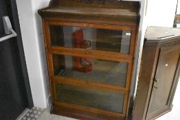 A late 19th or early 20th Century oak three tier stacking bookcase in the Globe Wernicke style ,
