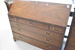 A Georgian mahogany bureau of wide proportions, having fitted interior, brass drop handles, on