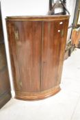 A 19th Century mahogany bow fronted corner cupboard, height approx. 111cm