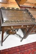 A Chippendale revival side table having lift off tray top and shaped undertier (some damage to