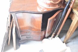 A reproduction regency mahogany serpentine fronted TV cabinet