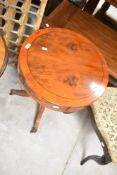 A reproduction Regency yew wood occasional table of drum form