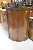 A 19th Century mahogany bow fronted corner cupboard, height approx. 114cm
