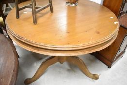 A traditional pine pedestal dining table having circular top and triple splay legs, diameter approx.