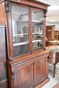 A Victorian mahogany bookcase having double cupboard base, width approx. 127cm