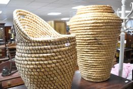 Two vintage coiled straw linen baskets including seat form