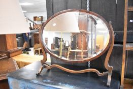 A Regency revival oval dressing table mirror of large proportions