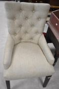 A modern button back style dining chair