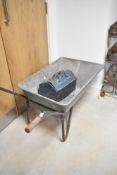 A vintage wheelbarrow and tool chest