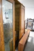 A Victorian walnut triple wardrobe having central mirror door, dimensions approx. H213 W196 D61cm,