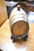 A small oak decorative sherry cask on stand, overall height approx. 33cm