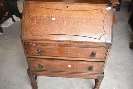 An early to mid 20th Century oak bureau