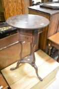 A Georgian mahogany night or plant stand, having circular top, with triform supports and splay legs,