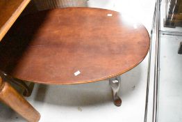 A reproduction mahogany oval topped coffee table
