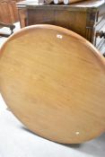 A vintage teak circular extending dining table, diameter approx. 108cm