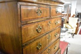 A Georgian walnut chest on stand, having brass handles, shaped apron and cabriole legs, dimensions