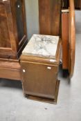 An Art Deco walnut bedside cabinet having marble top