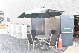 A modern garden table and chairs set, some damage to parasol