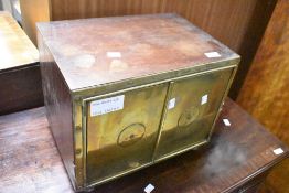 An Oriental style brass fronted safe, dimensions approx. width 41cm, height 32cm