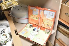 A large enamel roasting tin in white with red accents sold along with a Wallace and Gromit Wash & Go