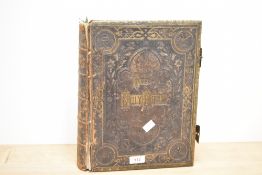 A 19th century Brown's Holy Family Bible bound in leather with metal clasps, h34cm