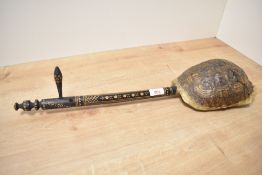 A tortoiseshell Gunibri guitar, the neck decorated with geometrical folk art patterns, L58cm