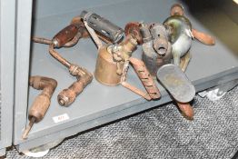 Two vintage brace drills, two brass blowtorches and a hand drill.