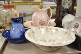 A Staffordshire water jug and bowl having pale pink glaze and rose pattern sold along with a smaller