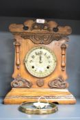 A late 19th century 'Newhavon, USA' oak cased 8 - day mantel clock having brass dial and carved