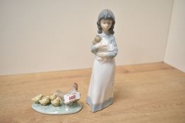 Two Nao by Lladro studies comprising 'Girl and Dog' model number 0118 and 'Hen with Chicks' model