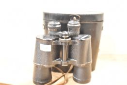 A single pair of binoculars with leather strap, factory mark '7x50 MADE IN USSR', suede lined