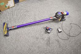 A Dyson V8 Absolute Cordless vacuum cleaner includes stair head and charger.