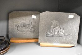 A slate plaque mounted on an oak base, engraved with squirrel on branch, signed Adrian Lewis-