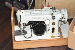 A cased singer sewing machine, label to side for 'The Singer Manufacturing Co', L50cm Condition