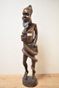An African tribal wooden statue depicting male figure and serpent, h63cm