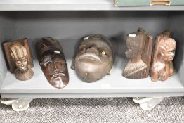 A hand carved wooden African tribal mask, having piercing white eyes, h28cm, sold together with