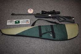 A Remmington Genesis .22 air rille with a 3-9 x 40 scope a cleaning kit and tin of pellets