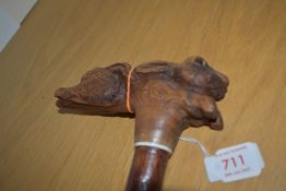A hand carved walking stick with a greyhound head and hares head 100cm approx