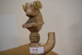 A walking stick with a rams head carved in wood and a thumb rest measuring 130cm long