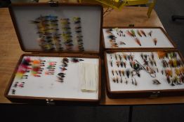 Two large double sided mahogany coloured fly presentation boxes containing mostly salmon or sea