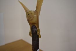 A walking stick with a carved owl measuring 135cm long slight damage to tip of wing