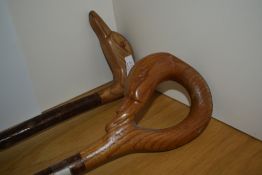Two walking sticks with carved duck or goose heads one measuring 90cm the other 100cm