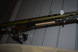 Four fibreglass spinnning rods one with a Daiwa A-400RL reel attached