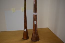 Two copper and brass post or hunting horns 133cm and 88cm long