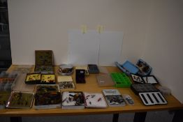 A collection of salmon and trout flies in several pocket boxes and tins