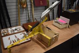 A clay pigeon trap and a box of clay pigeons