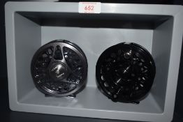 Two alloy 4 and a 1/4 inch Fly reels (look to be unused) one marked Predator line 9/11