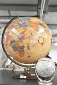 A World Globe raised on a wooden base, h38cm, sold together with 1 other, (2)