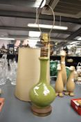 A vintage ceramic vase shaped lamp , in green, having metal base and shade, height to fitting
