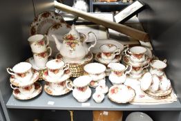A Royal Albert 'Old Country Rose' pattern dinner service having gilt edging and floral designs, to